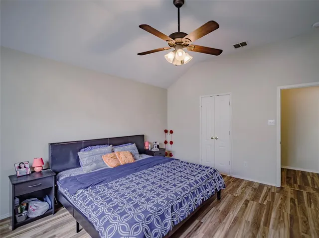 a bedroom with a bed and wooden floor