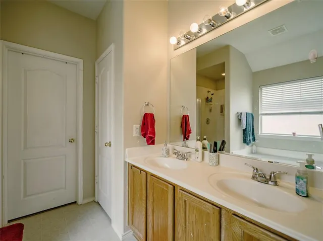 a bathroom with a double vanity sink mirror and double