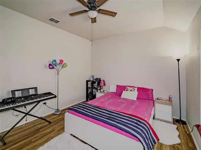 a bedroom with bed and a chandelier