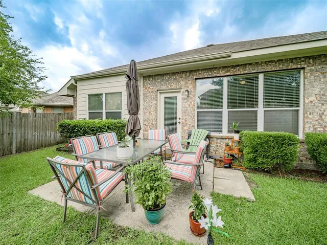 a view of a house with backyard sitting area and garden