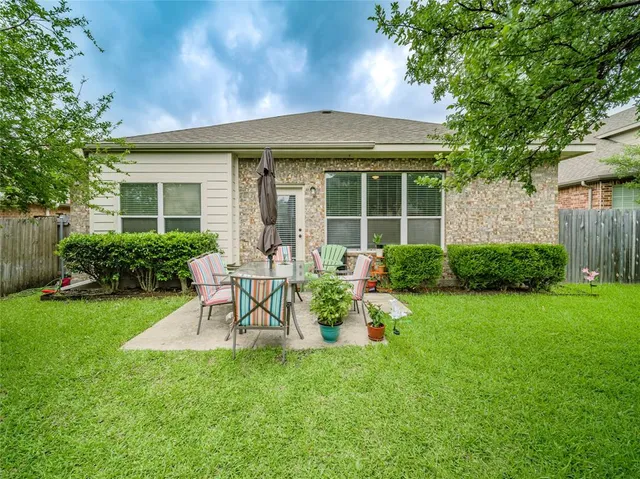 a view of a house with backyard sitting area and garden