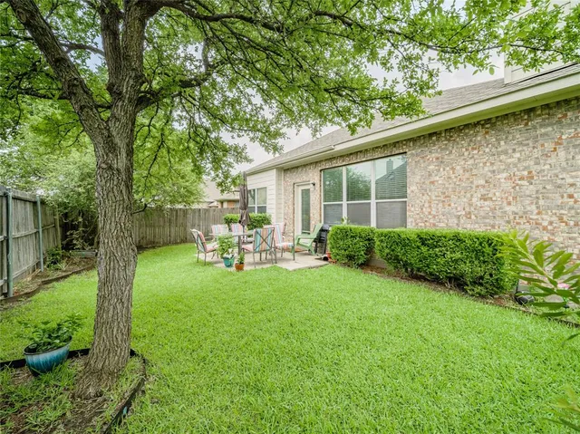 a view of backyard of a house with a patio