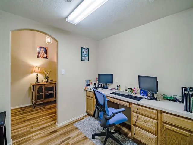 a view of a workspace with furniture and wooden floor