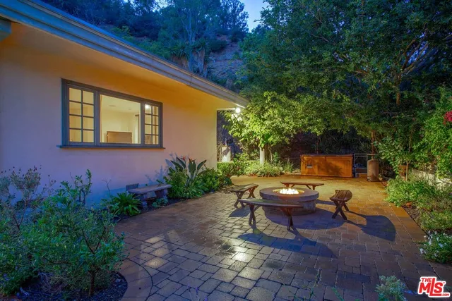 a view of backyard with outdoor seating and plants