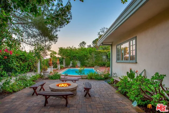 a backyard of a house with lots of green space and outdoor seating