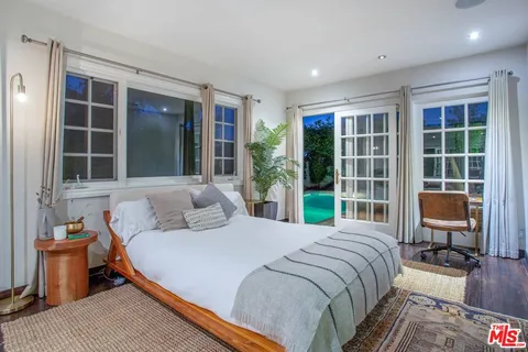 a bedroom with a large bed and a window