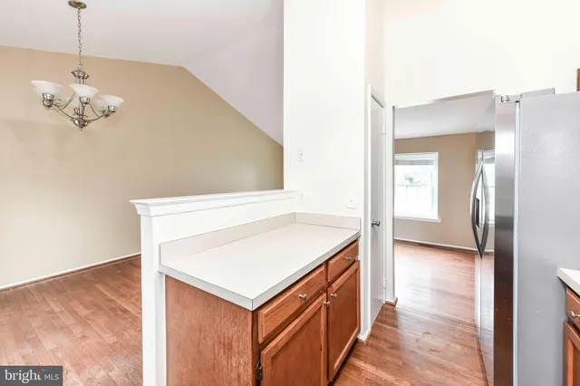an empty room with a window and a ceiling fan