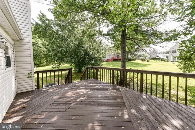 a view of backyard with deck and wooden floor