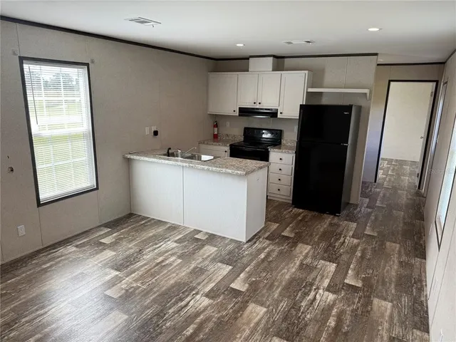 a kitchen with stainless steel appliances a refrigerator stove microwave and sink