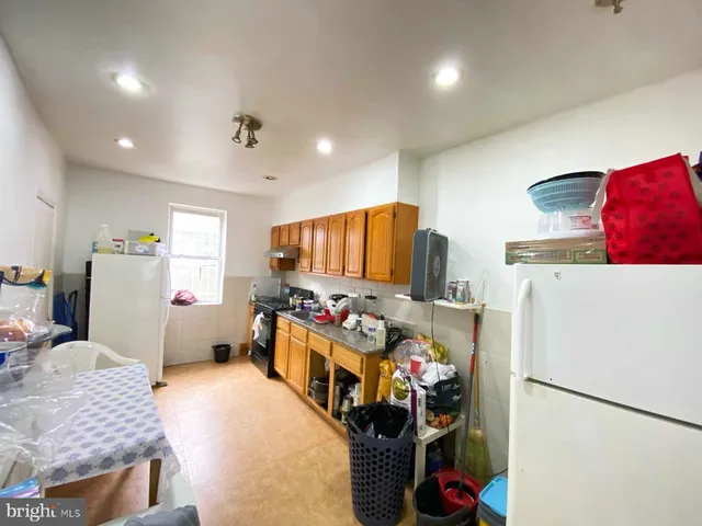 a kitchen with refrigerator and cabinets