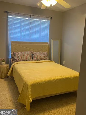 a bed sitting in a bedroom next to a blue wall