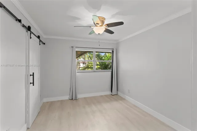 an empty room with fan and windows