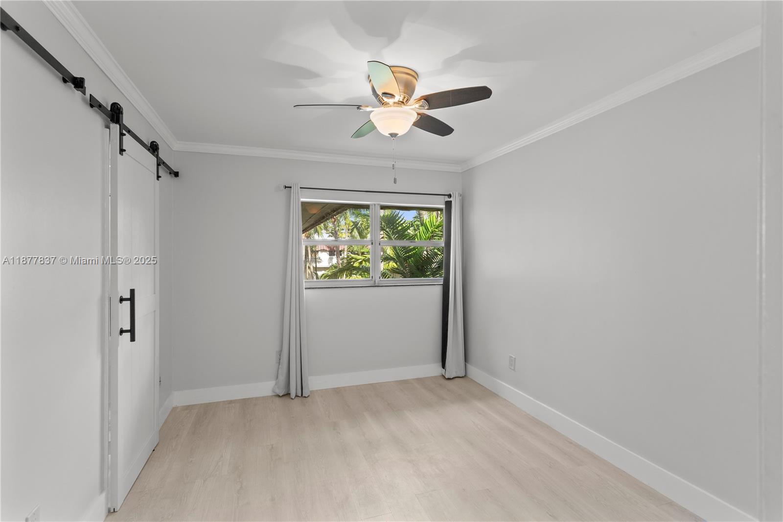 8600 Southwest 67th Avenue, Unit 937 Pinecrest, FL 33156 - Photo 7 of 24 an empty room with fan and windows