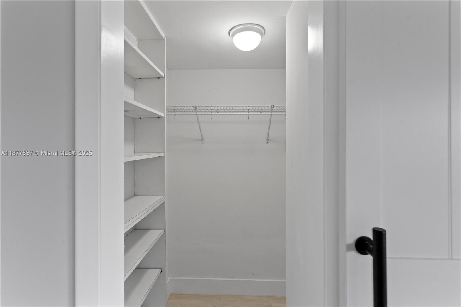 8600 Southwest 67th Avenue, Unit 937 Pinecrest, FL 33156 - Photo 9 of 24 a view of walk in closet with empty racks