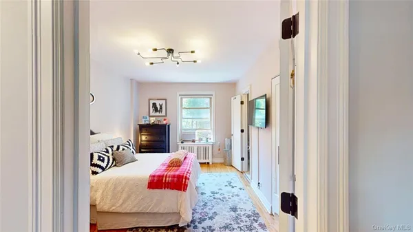 a bedroom with a bed and a chandelier