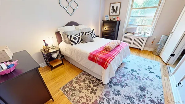 a bedroom with a bed next to a window with the outer view