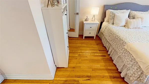a bedroom with a bed and a mirror
