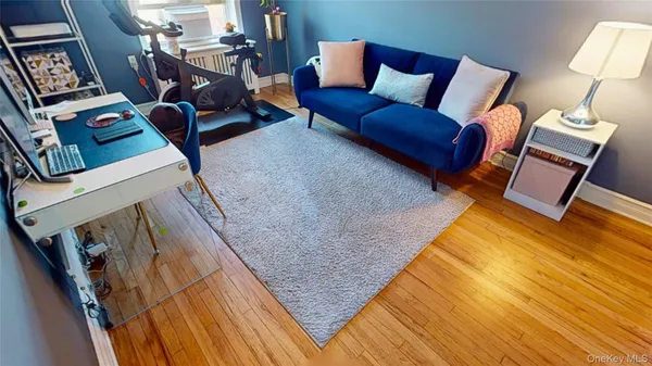 a living room with furniture a rug and a window