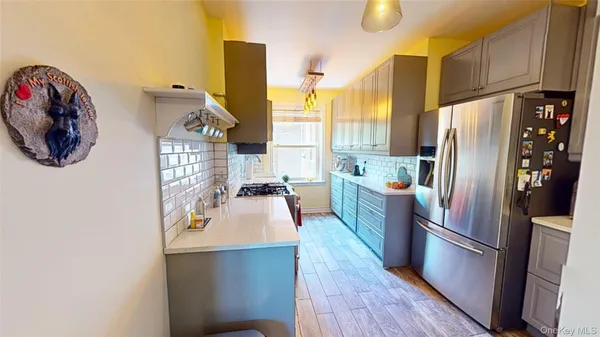 a kitchen with stainless steel appliances a refrigerator a sink and a stove