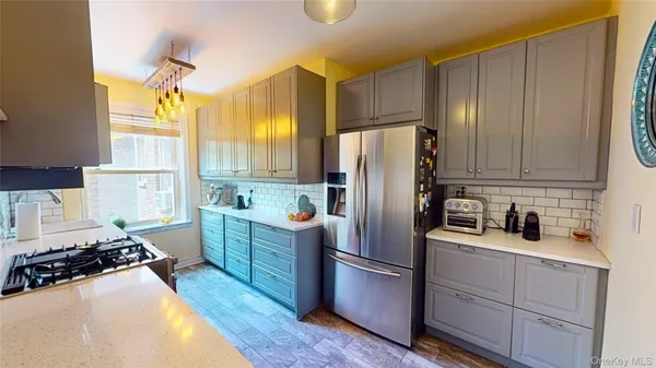 a kitchen with a refrigerator a sink dishwasher a stove and a refrigerator with wooden floor