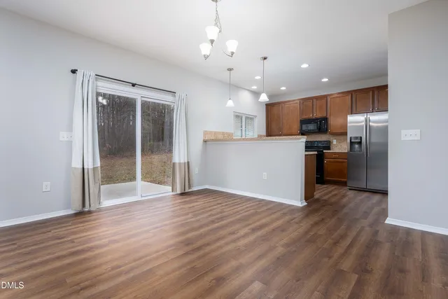 a view of a kitchen with a sink and a refrigerator