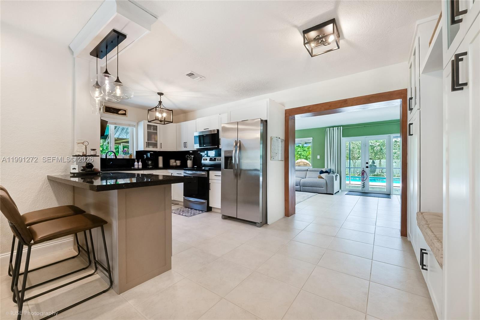8535 Southwest 97th Road Miami, FL 33173 - Photo 7 of 28 a kitchen with stainless steel appliances kitchen island granite countertop a refrigerator and a stove top oven