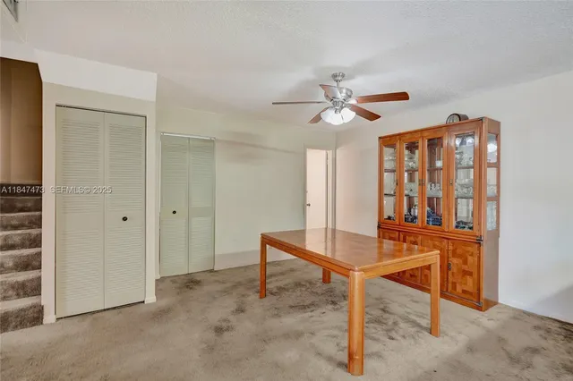 a workspace room with furniture and a chandelier fan