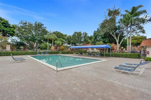 a view of a tennis court with trees in the background