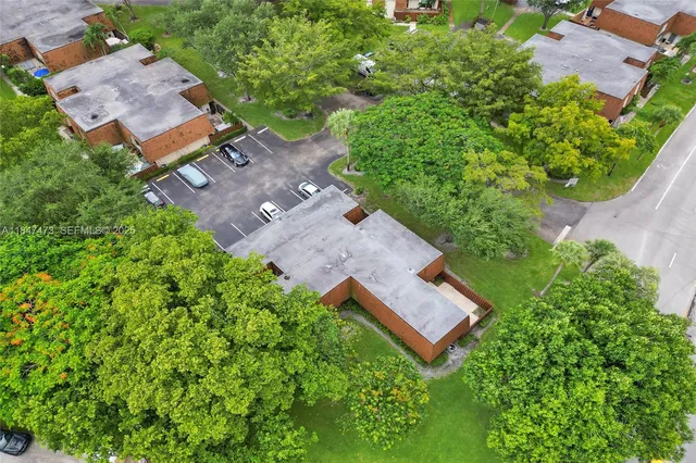 an aerial view of a house with garden space and a lake view