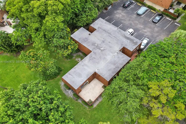 an aerial view of a house with a yard and trees