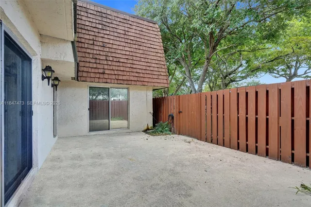 a view of a backyard with wooden fence