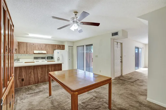 a living room with stainless steel appliances kitchen island granite countertop furniture and kitchen view