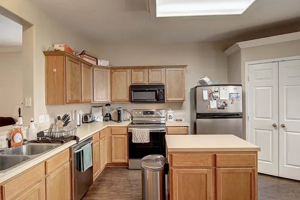 a kitchen with a sink a stove top oven and refrigerator