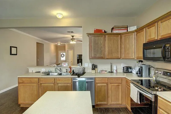 a kitchen with cabinets a sink and appliances