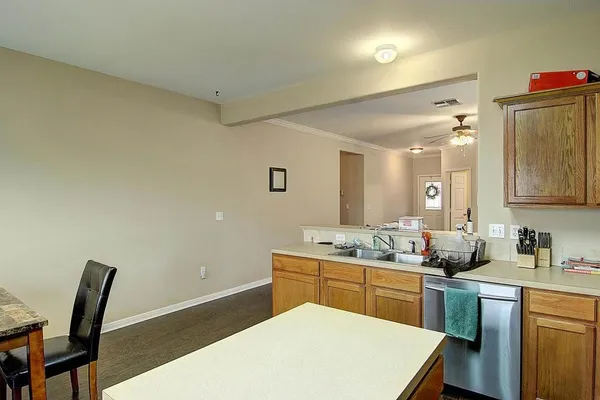 a kitchen with a sink a table and chairs