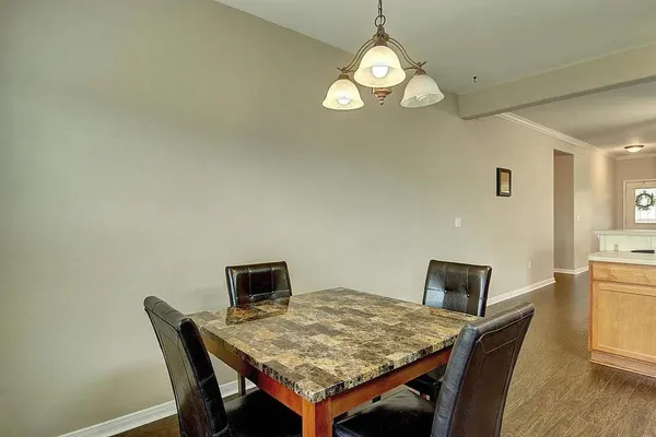a view of a dining room with a table and chairs