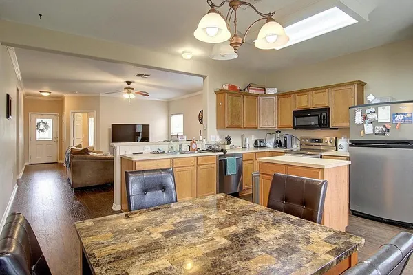 a kitchen with stove a sink and a refrigerator