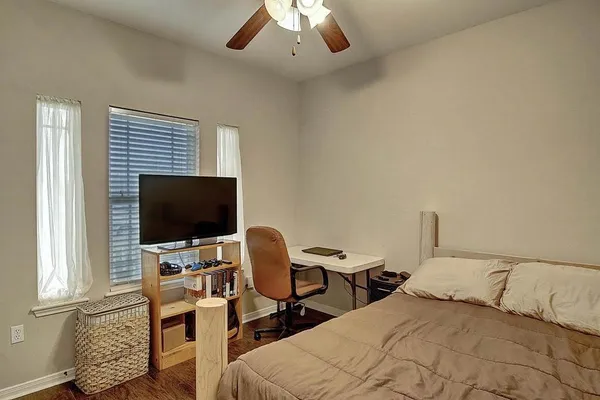 a bedroom with a bed and a chair