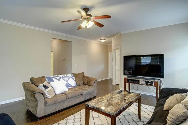 a living room with furniture and a flat screen tv