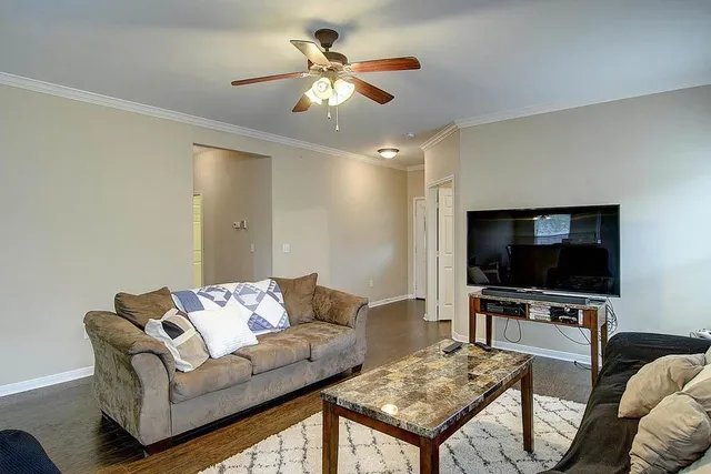 a living room with furniture and a flat screen tv