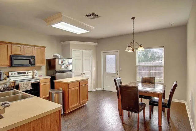 a view of a dining room with furniture window and wooden floor