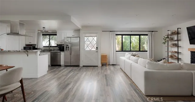 a living room with furniture and a kitchen