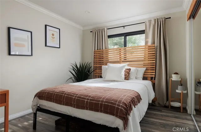 a bedroom with a large bed and a window