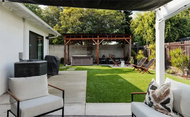 a view of a porch with furniture and garden
