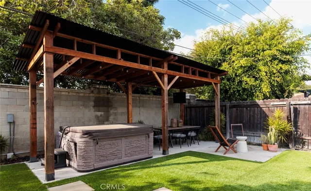 a view of backyard with a slide and wooden fence
