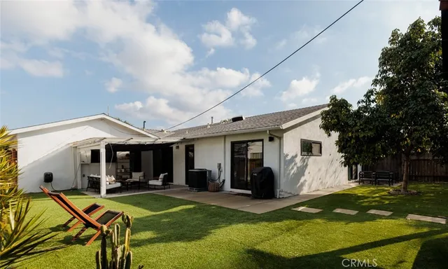 a view of a house with swimming pool and a yard