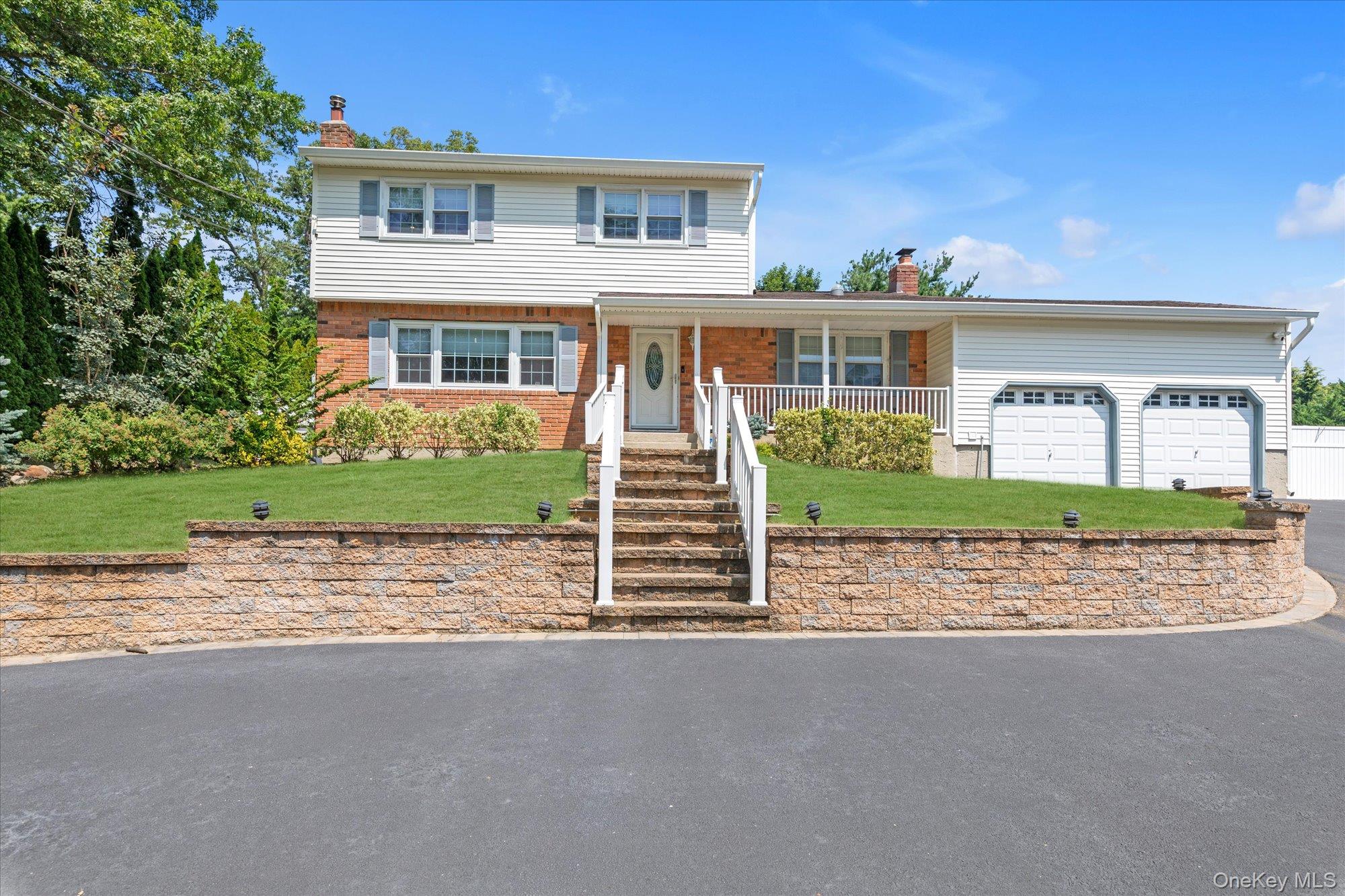 105 Lone Oak Path Smithtown, NY 11787 - Photo 1 of 1 a front view of a house with a garden