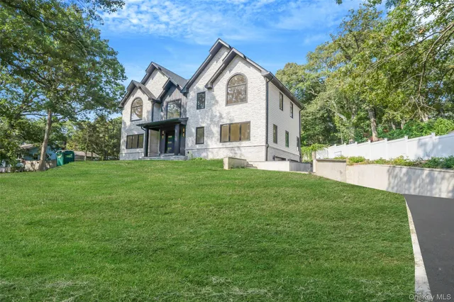 a front view of a house with a garden and yard