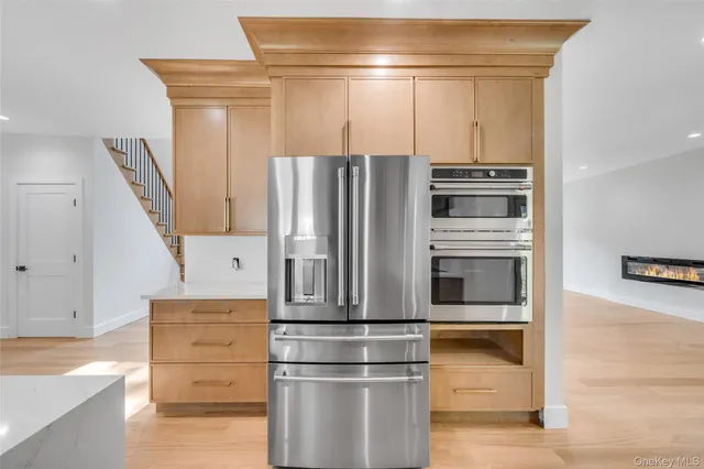 a metallic refrigerator freezer sitting in a kitchen