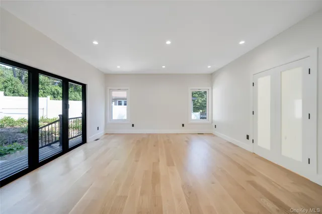 a view of a room with wooden floor and window